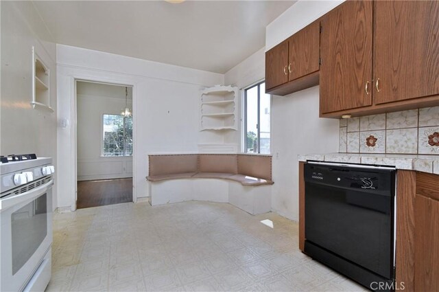 5625 Matilija Ave, Valley Glen, CA 91401 - kitchen featuring black dishwasher, white gas stove, light countertops, brown cabinetry, and plenty of natural light