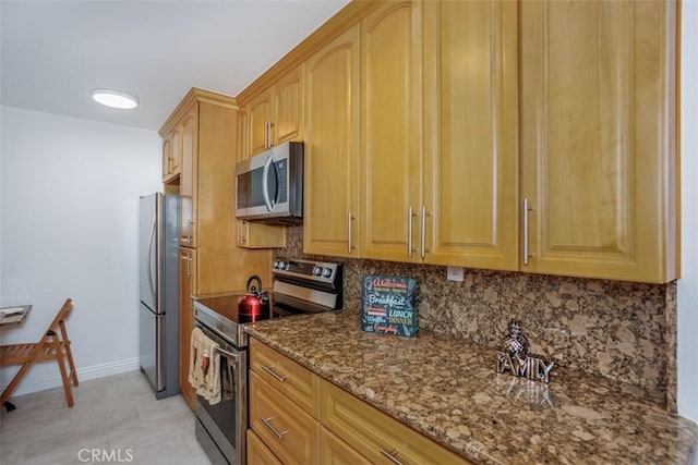 1115 S Elm Dr Unit 510, Los Angeles, CA 90035 - kitchen with appliances with stainless steel finishes, dark stone countertops, tasteful backsplash, and baseboards