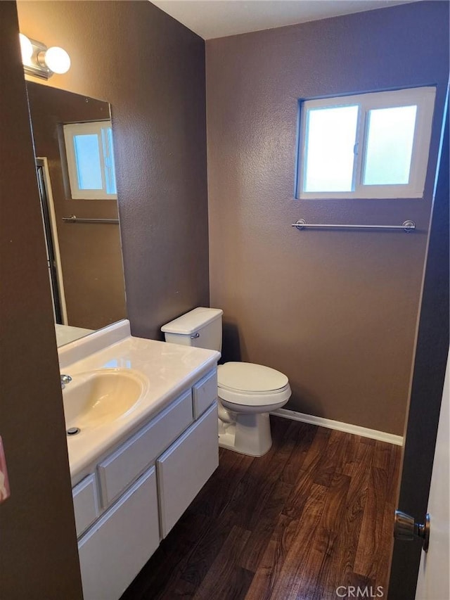 2120 Jacaranda Ct, San Bernardino, CA 92404 - bathroom featuring toilet, wood finished floors, vanity, a textured wall, and an enclosed shower