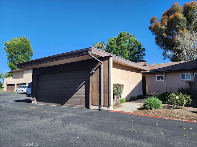 2120 Jacaranda Ct, San Bernardino, CA 92404 - view of property exterior featuring a garage and stucco siding