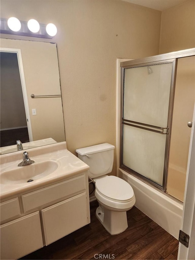 2120 Jacaranda Ct, San Bernardino, CA 92404 - full bathroom with vanity, wood finished floors, enclosed tub / shower combo, and toilet