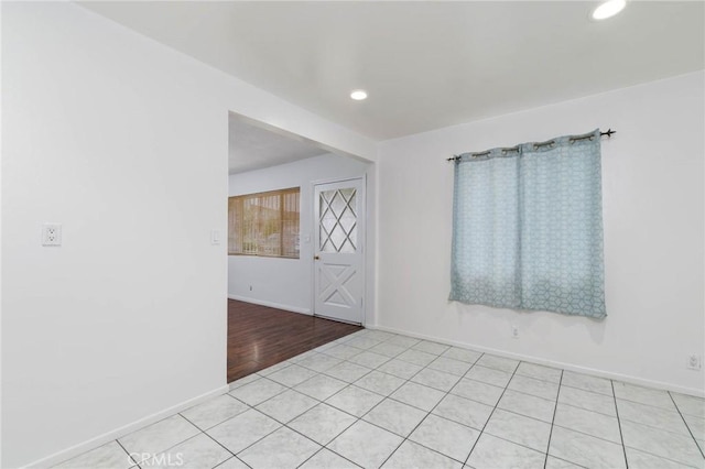 spare room with recessed lighting, baseboards, and light tile patterned flooring