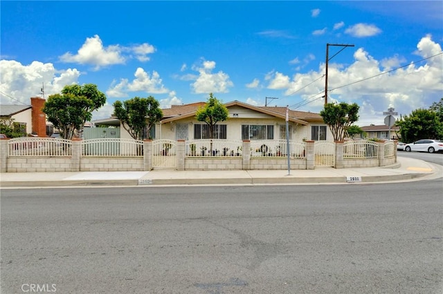 single story home with a fenced front yard and stucco siding