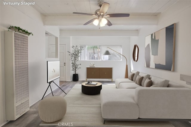 living area featuring a heating unit, wood finished floors, ceiling fan, and wooden ceiling with exposed beams