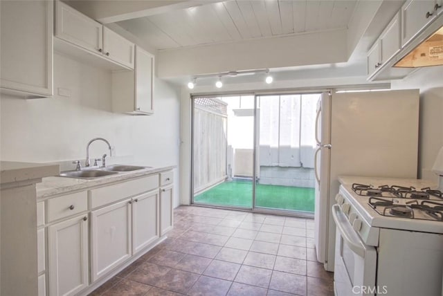kitchen featuring white range with gas stovetop, a sink, white cabinetry, and light countertops