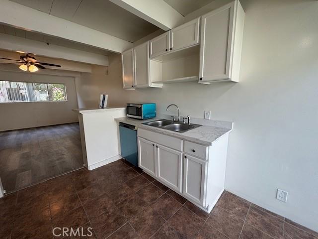 4040 Grand View Blvd Unit 41, Los Angeles, CA 90066 - kitchen with stainless steel microwave, dishwasher, beamed ceiling, white cabinetry, and ceiling fan