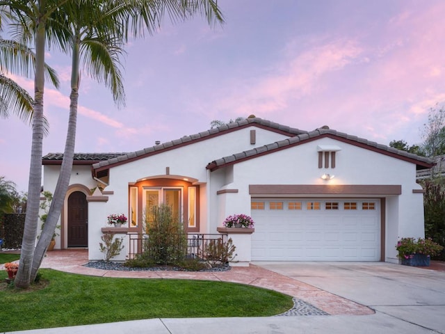 1002 Alexandra Ln, Encinitas, CA 92024 - mediterranean / spanish-style house with concrete driveway, an attached garage, stucco siding, a front yard, and a tiled roof