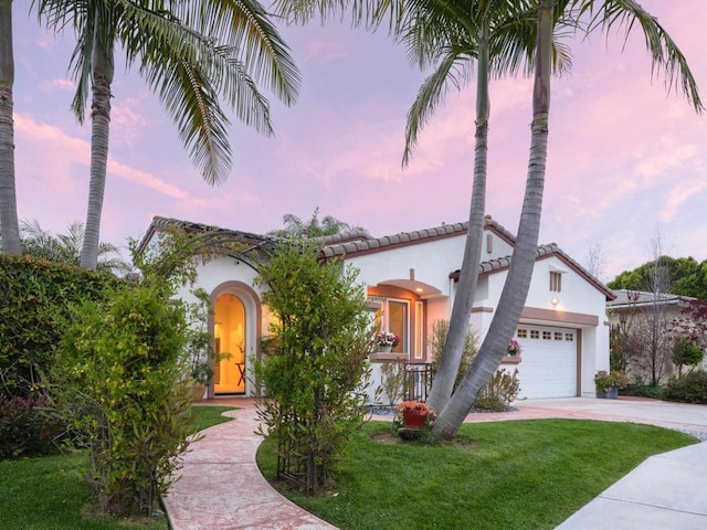 1002 Alexandra Ln, Encinitas, CA 92024 - mediterranean / spanish-style house with driveway, stucco siding, a front lawn, and a garage