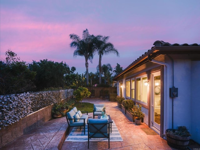 1002 Alexandra Ln, Encinitas, CA 92024 - patio terrace at dusk with a fenced backyard and an outdoor living space