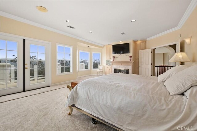 3211 E Mandeville Pl, Orange, CA 92867 - carpeted bedroom with access to exterior, ornamental molding, recessed lighting, a glass covered fireplace, and baseboards