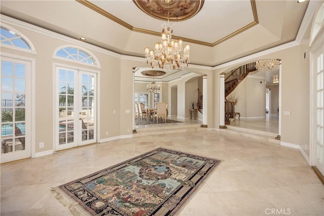 3211 E Mandeville Pl, Orange, CA 92867 - foyer with french doors, a chandelier, arched walkways, ornamental molding, and baseboards