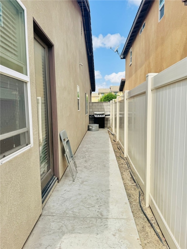 4772 Marrieta St, Jurupa Valley, CA 91752 - view of side of property with stucco siding, a fenced backyard, and a patio