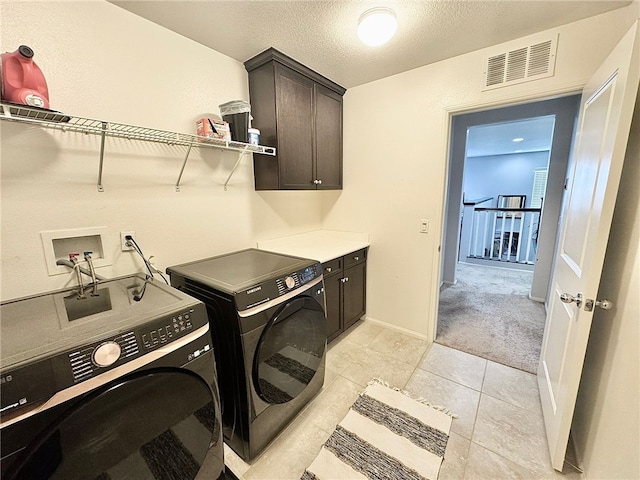 4772 Marrieta St, Jurupa Valley, CA 91752 - washroom featuring cabinet space, washer and clothes dryer, light tile patterned floors, a textured ceiling, and baseboards