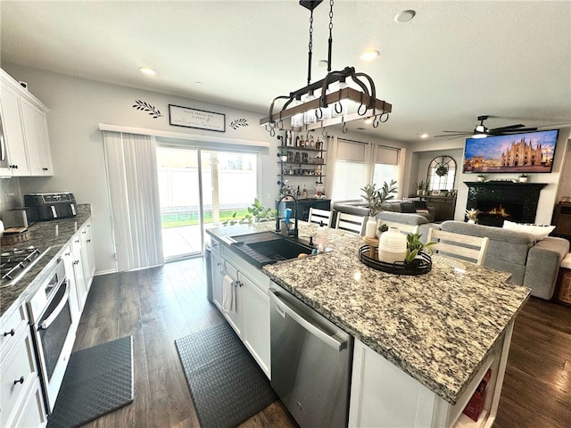 4772 Marrieta St, Jurupa Valley, CA 91752 - kitchen with appliances with stainless steel finishes, a sink, a kitchen island with sink, white cabinets, and open floor plan