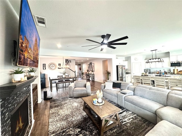 4772 Marrieta St, Jurupa Valley, CA 91752 - living area with a chandelier, a warm lit fireplace, wood finished floors, a ceiling fan, and recessed lighting