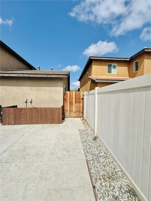 4772 Marrieta St, Jurupa Valley, CA 91752 - view of side of property with stucco siding, a tiled roof, and a patio