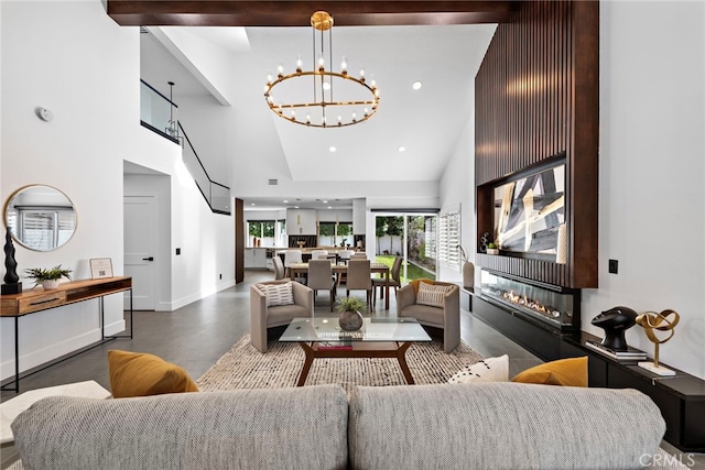 11 Bayside, Irvine, CA 92614 - living area featuring high vaulted ceiling, a chandelier, a glass covered fireplace, recessed lighting, and baseboards