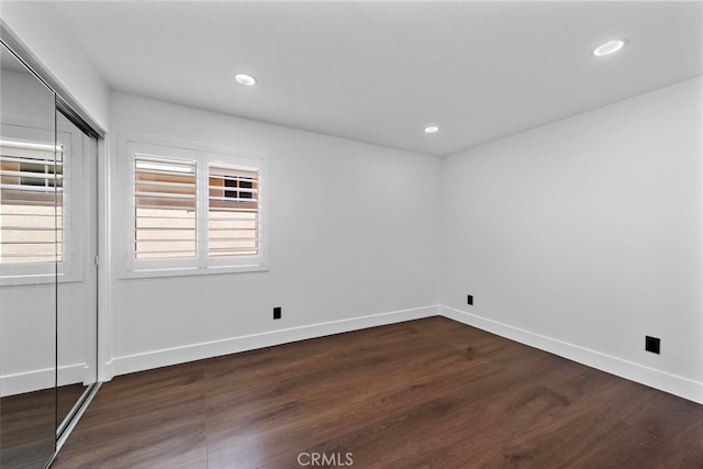 11 Bayside, Irvine, CA 92614 - unfurnished room featuring dark wood-style floors, recessed lighting, and baseboards