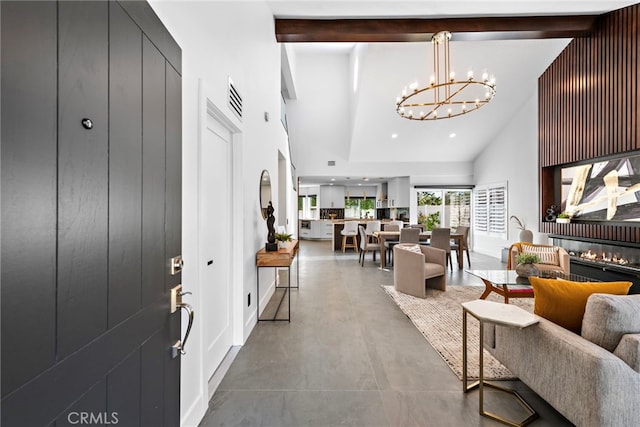 11 Bayside, Irvine, CA 92614 - foyer entrance with high vaulted ceiling, beam ceiling, a chandelier, concrete flooring, and a glass covered fireplace