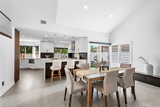 11 Bayside, Irvine, CA 92614 - dining area with recessed lighting, high vaulted ceiling, and baseboards