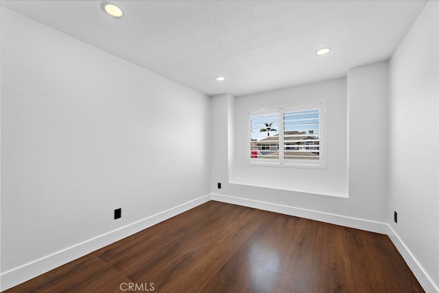 11 Bayside, Irvine, CA 92614 - unfurnished room with baseboards, dark wood-style flooring, and recessed lighting