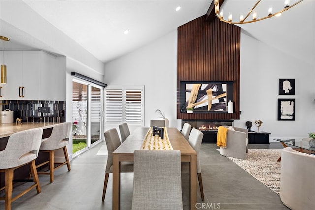 11 Bayside, Irvine, CA 92614 - dining space featuring high vaulted ceiling, concrete floors, a chandelier, and recessed lighting