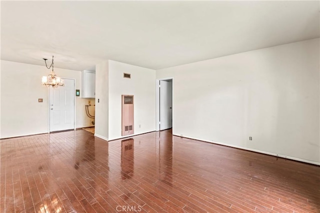 4303 Kansas Ave, Riverside, CA 92507 - spare room with a chandelier, wood finished floors, baseboards, and a heating unit
