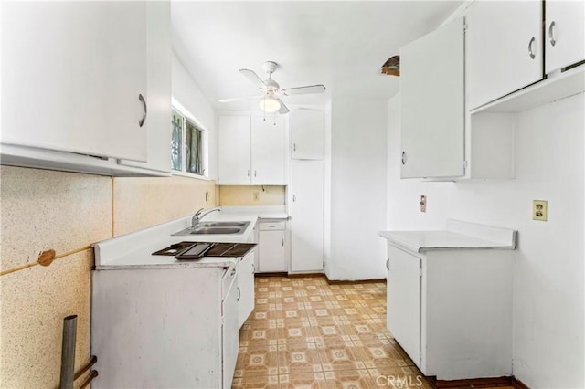4303 Kansas Ave, Riverside, CA 92507 - kitchen with a ceiling fan, a sink, white cabinetry, light countertops, and light floors