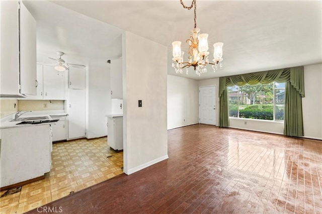 4303 Kansas Ave, Riverside, CA 92507 - unfurnished dining area featuring a chandelier, a sink, a ceiling fan, baseboards, and light wood-style flooring