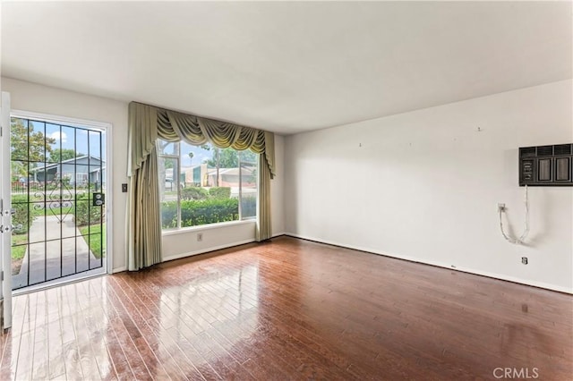 4303 Kansas Ave, Riverside, CA 92507 - unfurnished living room featuring hardwood / wood-style flooring and baseboards