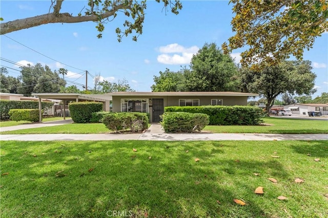 4303 Kansas Ave, Riverside, CA 92507 - single story home with an attached carport, a front yard, stucco siding, and concrete driveway