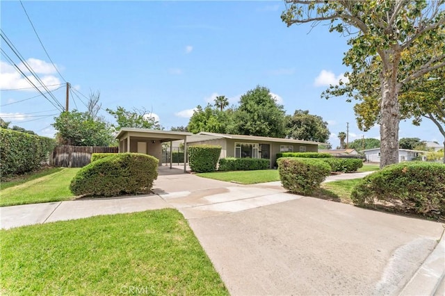4303 Kansas Ave, Riverside, CA 92507 - view of front of property featuring driveway, stucco siding, and an attached carport