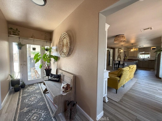 17857 Main St, Hesperia, CA 92345 - entryway with wood finished floors, baseboards, a textured ceiling, and a textured wall