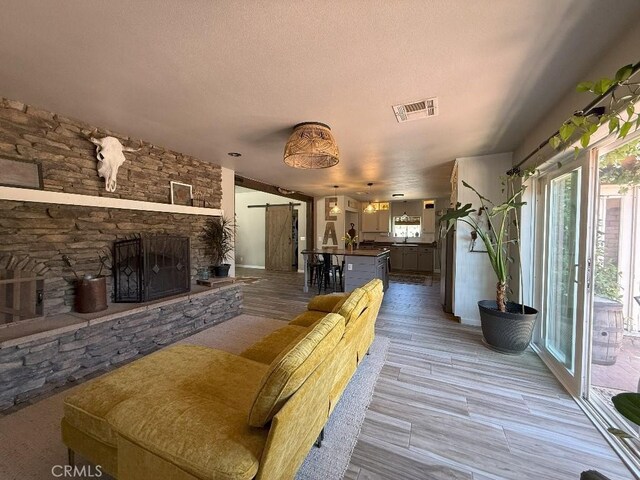 17857 Main St, Hesperia, CA 92345 - living room with light wood finished floors, baseboards, and a fireplace