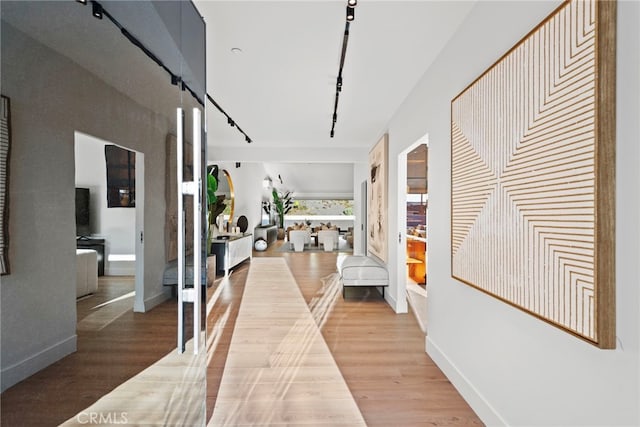 1318 Outrigger Dr, Corona Del Mar, CA 92625 - corridor featuring light wood-style flooring, track lighting, and baseboards
