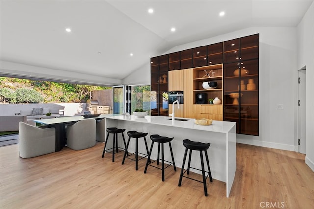 1318 Outrigger Dr, Corona Del Mar, CA 92625 - kitchen featuring modern cabinets, lofted ceiling, a sink, open shelves, and a kitchen breakfast bar