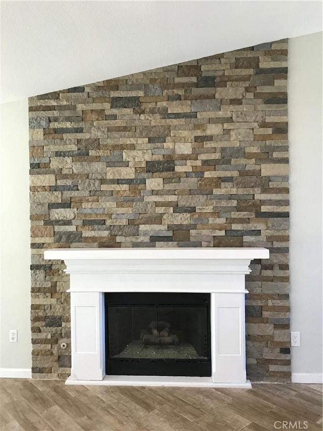 26021 Crestmont Cir, Menifee, CA 92586 - detailed view of a glass covered fireplace, wood finished floors, and baseboards