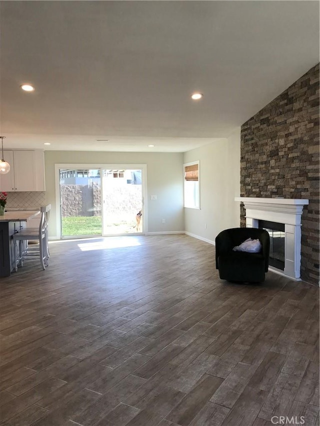 26021 Crestmont Cir, Menifee, CA 92586 - living room with a fireplace, dark wood finished floors, recessed lighting, and baseboards