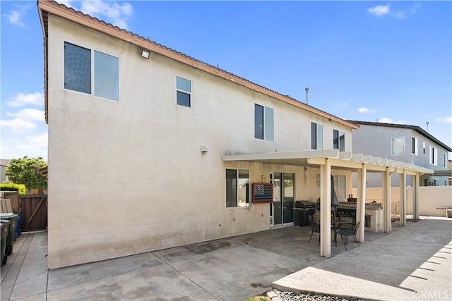 7311 Pinewood Ct, Eastvale, CA 92880 - rear view of house with a pergola, a patio, and stucco siding