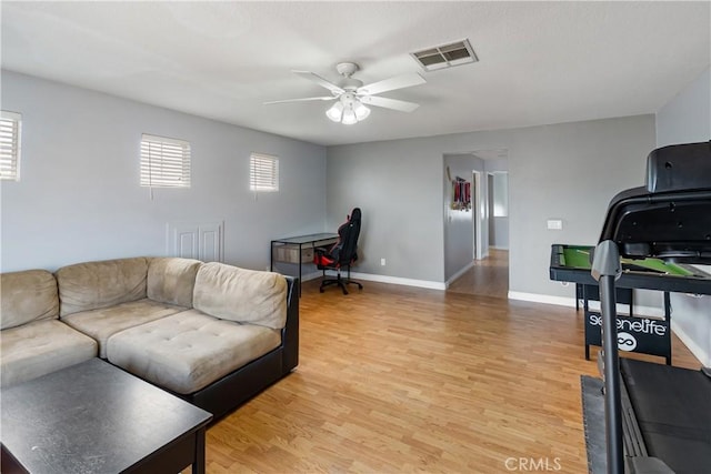 7311 Pinewood Ct, Eastvale, CA 92880 - living area with light wood-type flooring, a ceiling fan, and baseboards