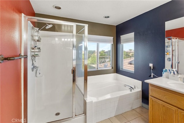 7311 Pinewood Ct, Eastvale, CA 92880 - bathroom featuring a shower stall, a garden tub, vanity, and a textured wall
