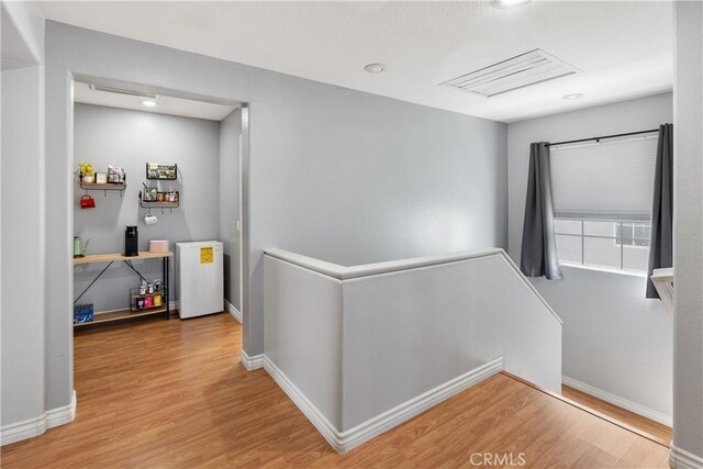7311 Pinewood Ct, Eastvale, CA 92880 - corridor with an upstairs landing, wood finished floors, baseboards, and recessed lighting