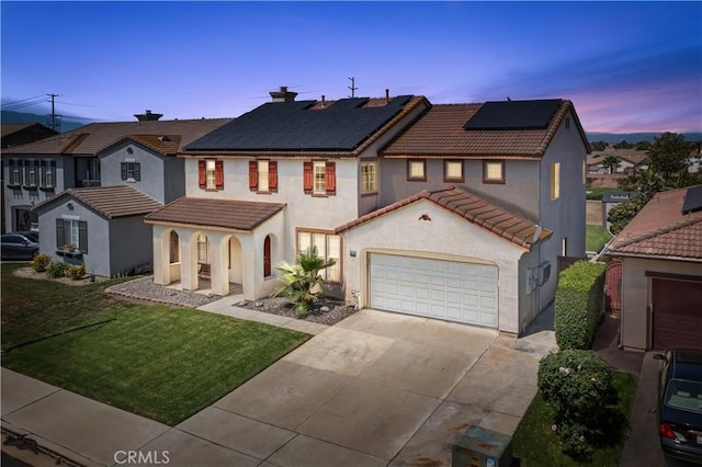 7311 Pinewood Ct, Eastvale, CA 92880 - view of front of home featuring a tile roof, concrete driveway, stucco siding, a yard, and solar panels