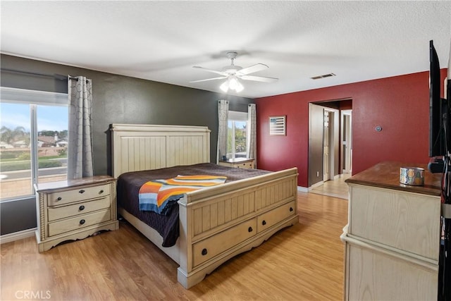 7311 Pinewood Ct, Eastvale, CA 92880 - bedroom with multiple windows, light wood-style flooring, and baseboards