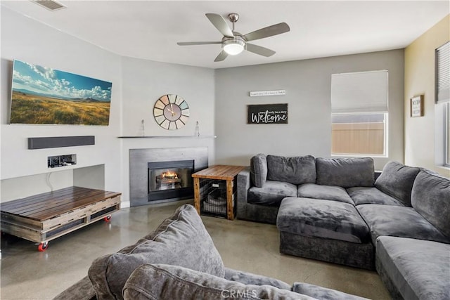 7311 Pinewood Ct, Eastvale, CA 92880 - living room with a glass covered fireplace, ceiling fan, and concrete flooring