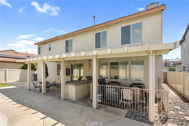 7311 Pinewood Ct, Eastvale, CA 92880 - rear view of house with stucco siding, a fenced backyard, and a patio
