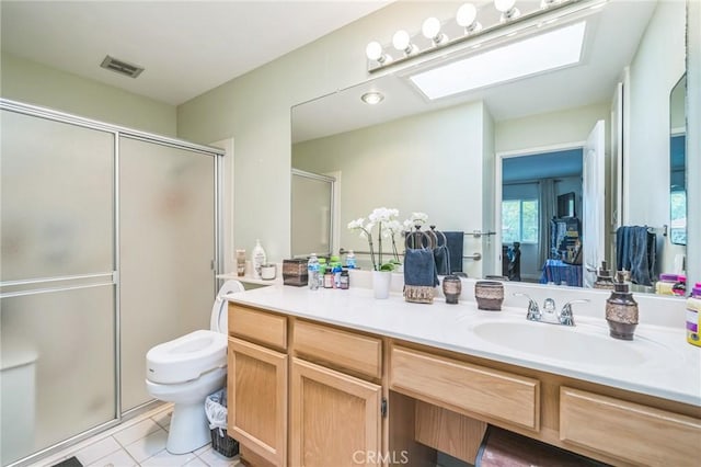 16511 Caminito Vecinos Unit 59, San Diego, CA 92128 - full bathroom with a skylight, a shower stall, tile patterned floors, and vanity