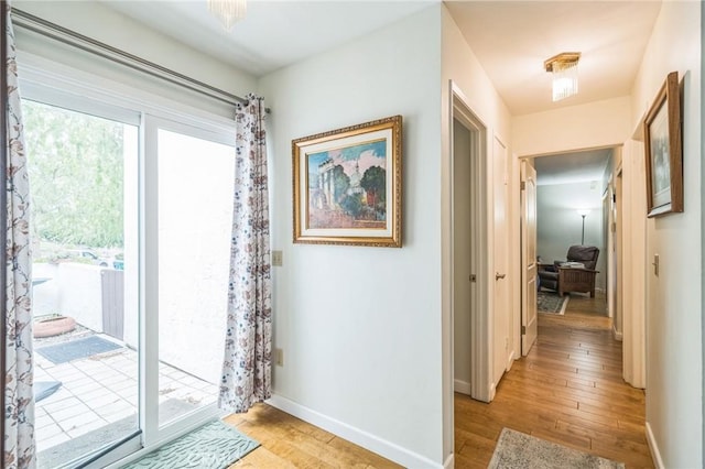 16511 Caminito Vecinos Unit 59, San Diego, CA 92128 - doorway featuring light wood-style floors and baseboards
