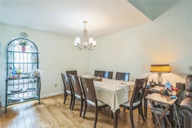 16511 Caminito Vecinos Unit 59, San Diego, CA 92128 - dining room featuring a chandelier, light wood-type flooring, and baseboards