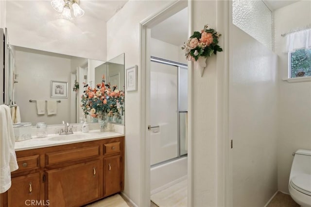 24571 Albrun Dr, Crestline, CA 92325 - bathroom with toilet, vanity, and shower / bath combination with glass door